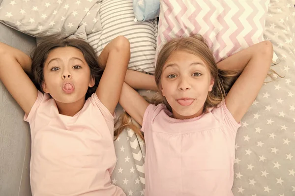 Leisure and fun. Having fun with best friend. Children playful cheerful mood having fun together. Pajama party and friendship. Sisters happy small kids relaxing in bedroom. Friendship of small girls — Stock Photo, Image