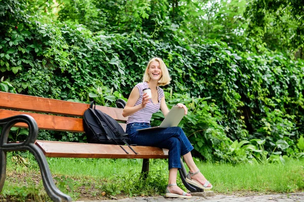 Mi godo la vita universitaria. Una ragazza lavora sul portatile. estate online. Grafico mattutino. ragazza bere caffè per andare. Rilassati nel parco. donna moderna con computer all'aperto. Bella donna che beve caffè da asporto — Foto Stock