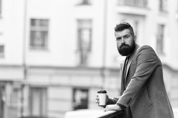 Relax and recharge. Man bearded hipster drinking coffee paper cup. One more sip of coffee. Enjoying coffee on the go. Businessman well groomed appearance enjoy coffee break out of business center — Stock Photo, Image