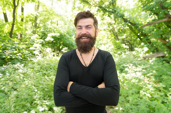 Immersing himself in a vacation in close contact with nature. Bearded man enjoying summer vacation. Happy caucasian guy going on vacation on natural landscape. Hipster smiling during vacation travel — Stock Photo, Image