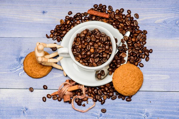 Fresh roasted coffee beans. Caffeine concept. Coffee shop concept. Cafe drinks menu. Coffee break and relax. Inspiration and energy charge. Cup full coffee brown roasted bean blue wooden background