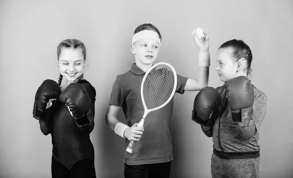 Friends ready for sport training. Sporty siblings. Child might excel completely different sport. Girls kids with boxing sport equipment and boy tennis player. Ways to help kids find sport they enjoy