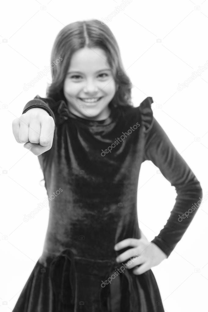 Modern feminism. small pretty girl with happy face hold fist. skincare and kid hairdresser. childrens day. childhood happiness. beauty and fashion. little girl child isolated on white. punching