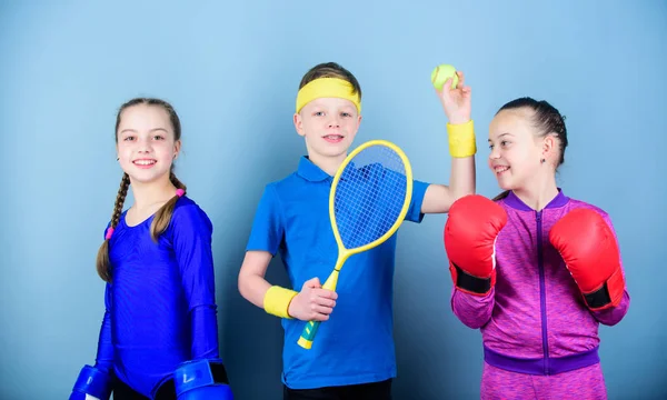 Friends ready for sport training. Child might excel completely different sport. Sporty siblings. Girls kids with boxing sport equipment and boy tennis player. Ways to help kids find sport they enjoy