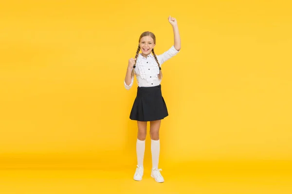 Känslomässig skolflicka. Fira kunskapsdagen. September dags att studera. Flicka förtjusande elev på gul bakgrund. Skoluniform och mode. Tillbaka till skolan. Studerande liten unge avgudar skolan — Stockfoto