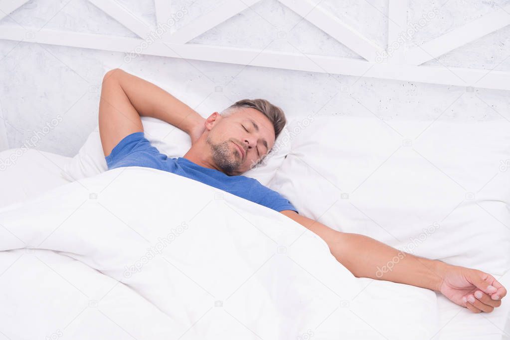 Tips sleeping better. Bearded peaceful man sleeping face relaxing on pillow covered blanket. Total relaxation. Healthy habits. Man handsome guy lay in bed sleeping. Get enough amount of sleep