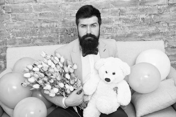 The quickest way to show you care. Love spring. international spring holiday. Spring gift. Bearded man hipster with spring flowers. Flower for March 8. Womens day. Bearded man with tulip and bear — Stock Photo, Image