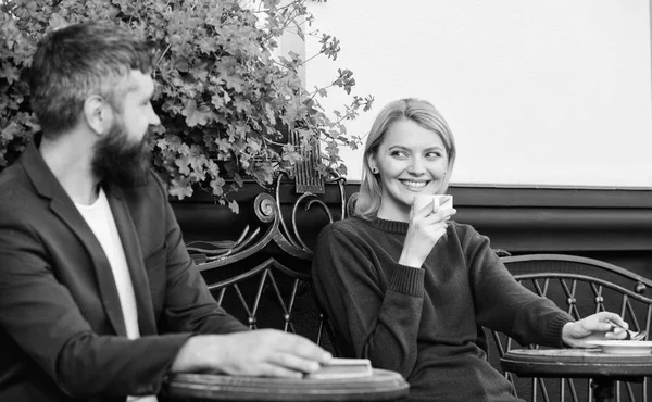 Enjoying beautiful morning. First meet of girl and mature man. woman and man with beard relax in cafe. Couple in love on romantic date. Morning coffee. Brutal bearded hipster and girl drink coffee — Stock Photo, Image