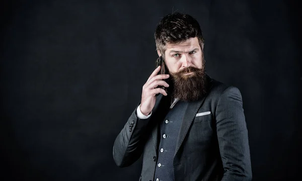 Concentrated on work. brutal caucasian hipster with moustache. Male formal fashion. businessman in suit. business communication. Mature hipster with beard speak on phone. Bearded man with smartphone — Stock Photo, Image