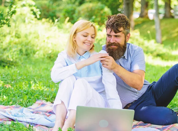 How to balance freelance and family life. Couple in love or family work freelance. Freelance life benefit concept. Modern online business. Couple youth spend leisure outdoors working with laptop