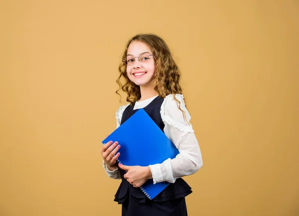 Final exam coming. Girl hold textbook folder test. Preparing to exams in library. Small child formal wear. Formal education and homeschooling. Check knowledge. School exam concept. Prepare for exam — Stock Photo, Image