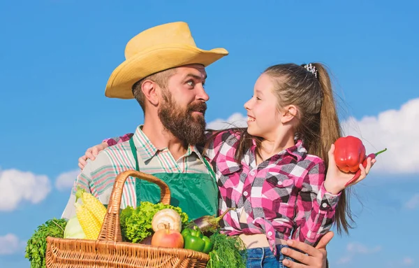 Father and daughter hold basket harvest vegetables. Gardening and harvesting. Family farm concept. Only organic and fresh harvest. Man bearded rustic farmer with kid. Farmer family homegrown harvest — Stock Photo, Image