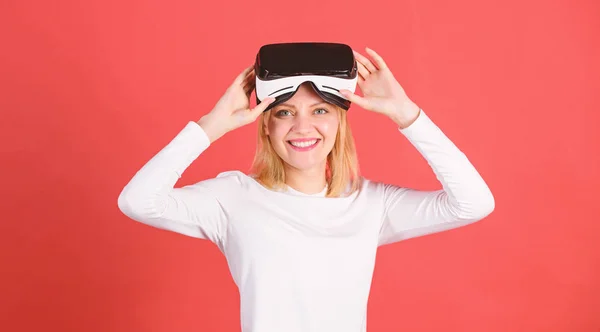 Woman using virtual reality headset. Woman watching virtual reality vision. Portrait of young woman wearing VR goggles, experiencing virtual reality using 3d headset. 3d entertainment.