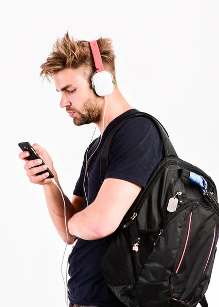 new technology in modern life. sexy muscular man listen music. man listen new song isolated on white. unshaven man in blue tooth technology earphones. moder life concept. Enjoying work music