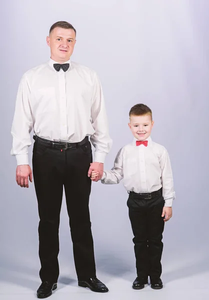 event manager. male fashion. parenting. fathers day. small boy with dad businessman. family day. father and son in formal suit. happy child with father. business meeting party. tuxedo style