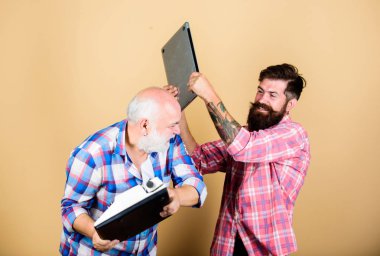 Modern yaşam ve geçmişin kalıntıları. Eski nesil. Dijital teknolojiler. Erkekler yazma aletleriyle çalışır. Daktilove hipster dizüstü bilgisayar ile kıdemli adam. Teknoloji savaşı. Yeni teknolojilere hakim