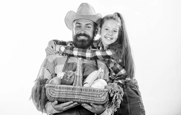 Family farm organic vegetables. Farmers family homegrown harvest. Gardening and harvesting. Father farmer or gardener with daughter hold basket harvest vegetables. Man bearded rustic farmer with kid — Stock Photo, Image