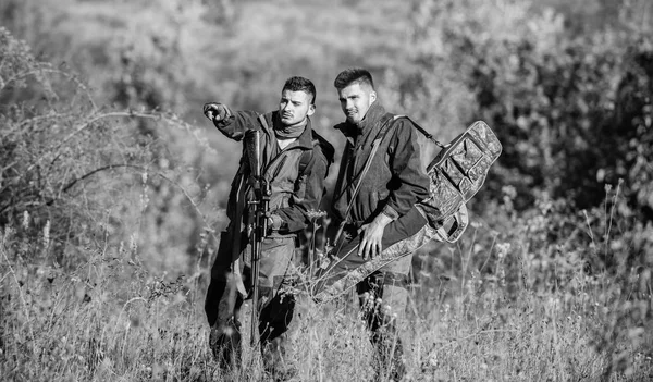 Cacciatori con fucili in ambiente naturale. Socio bracconiere nel crimine. Attività per uomini veri concetto. Cacciatori guardiacaccia in cerca di animali o uccelli. Caccia illegale. Amici cacciatori godono il tempo libero — Foto Stock