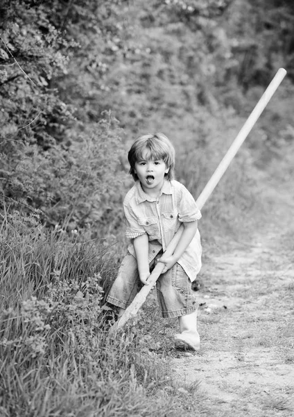 I want to find treasures. Little boy with shovel looking for treasures. Happy childhood. Adventure hunting for treasures. Little helper working in garden. Cute child in nature having fun with shovel