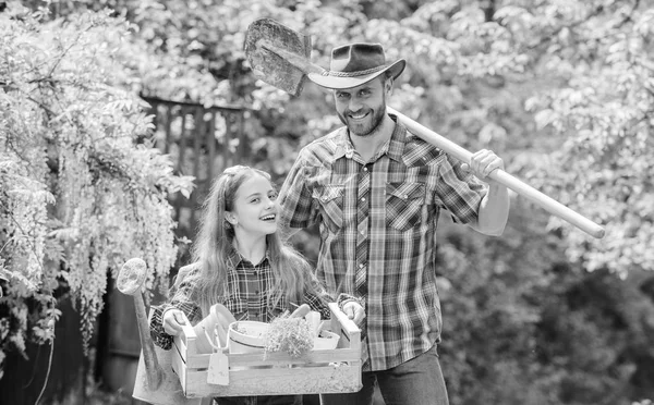 Inspect your garden daily to spot insect trouble early. Family dad and daughter little girl planting plants. Day at farm. Planting flowers. Plant veggies. Planting season. Popular in garden care — Stock Photo, Image