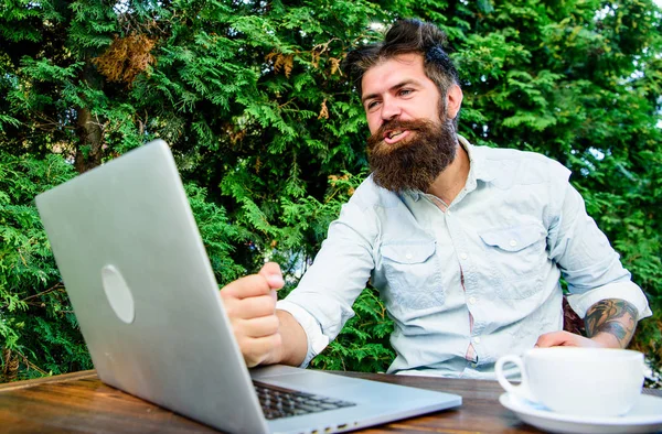 Well done. Hipster busy with freelance. Wifi and laptop. Drink coffee and work faster. Bearded man successful freelance worker. Remote job. Freelance professional occupation. Good job expression — Stock Photo, Image