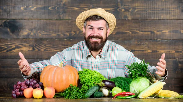 Vender verduras. Hombre agricultor barbudo con fondo de estilo rústico verduras. Comprar verduras granja local. Concepto de cultivos cultivados localmente. Mercado local. Hortalizas de cosecha propia. Festival de cosecha del mercado agrícola —  Fotos de Stock