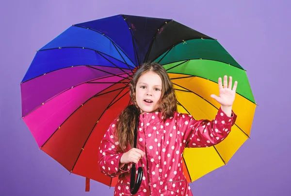 happy little girl with colorful umbrella. autumn fashion. cheerful hipster child in positive mood. rain protection. Rainbow. little girl in raincoat. Pure feelings. hello autumn