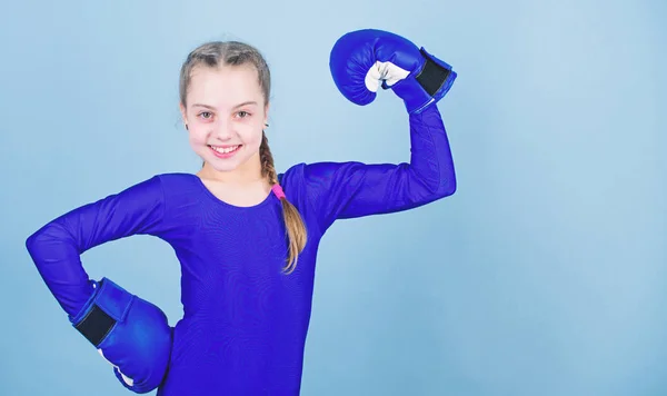 Be strong. punching knockout. Childhood. workout of small girl boxer. Sport success. sportswear fashion. Fitness diet. energy health. Happy child sportsman in boxing gloves. Strength and motivation