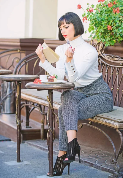 Self improvement concept. Literature for female. Mug of good coffee and pleasant book best combination for perfect weekend. Girl drink coffee read book. Woman have drink enjoy good book cafe terrace