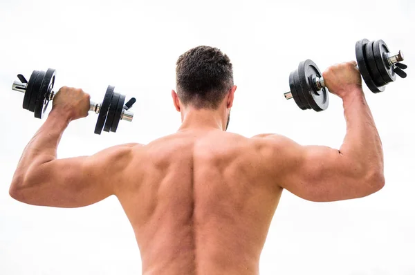 Actions speak louder than coaches. Dumbbell exercise gym. Muscular man exercising with dumbbell rear view. Sportsman with strong back and arms. Sport equipment. Bodybuilding sport. Sport lifestyle — Stock Photo, Image
