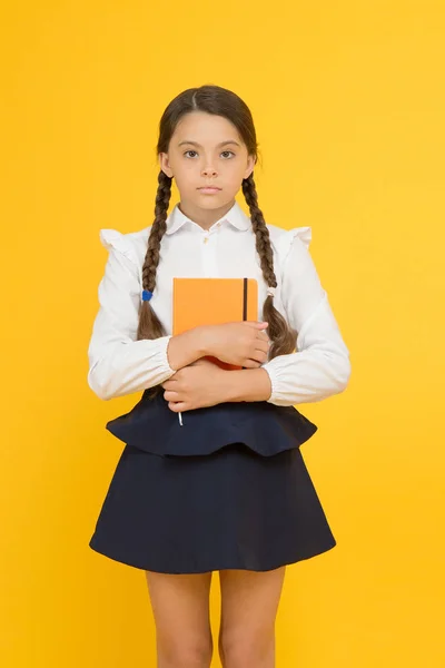 Study foreign language. Essay for homework. KId girl student likes to study. Study literature. Private lesson. Adorable child schoolgirl hold copybook. Formal education. School club after classes — Stock Photo, Image