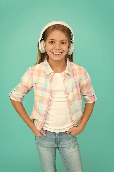 Listen to music. Beauty and fashion. Childhood happiness. Mp3 player. childrens day. Audio technology. small kid listen ebook, education. small girl child in headphones. Best song for his training