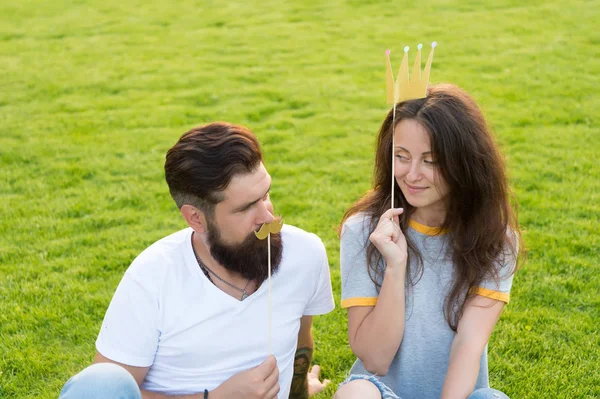 Youth day. Carefree couple having fun green lawn. Couple in love cheerful youth booth props. Man bearded hipster and pretty woman cheerful faces. Summer entertainment. Emotional people. Couple dating