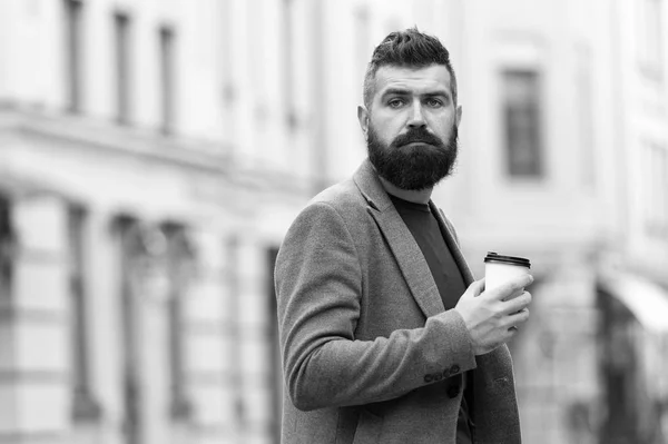 One more sip of coffee. City lifestyle. Businessman well groomed appearance enjoy coffee break out of business center urban background. Relax and recharge. Man bearded hipster drink coffee paper cup — Stock Photo, Image