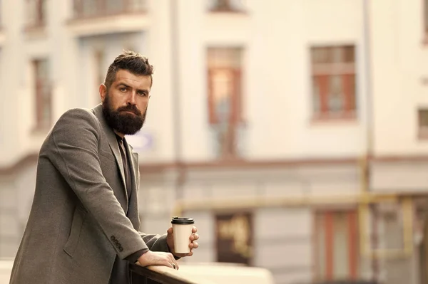 Relax and recharge. Man bearded hipster drinking coffee paper cup. One more sip of coffee. Enjoying coffee on the go. Businessman well groomed appearance enjoy coffee break out of business center — Stock Photo, Image