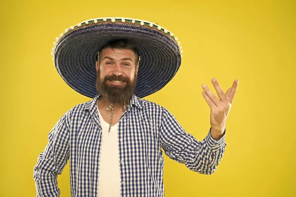 Mexican party concept. Celebrate traditional mexican holiday. Lets have fun. Mexican guy happy festive outfit ready to celebrate. Man bearded cheerful guy wear sombrero mexican hat yellow background