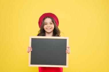 advertising board for promotion. back to school. school shopping sales. child on yellow background. happy girl in french beret. small girl kid with school backboard, copy space. publishing business clipart