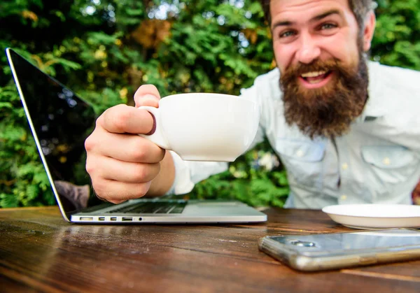 Bearded man freelance worker. Remote job. Freelance professional occupation. Online blog. Caffeine booster for productivity. Blogger freelance editor. Workaholic stereotype. Drink coffee work faster