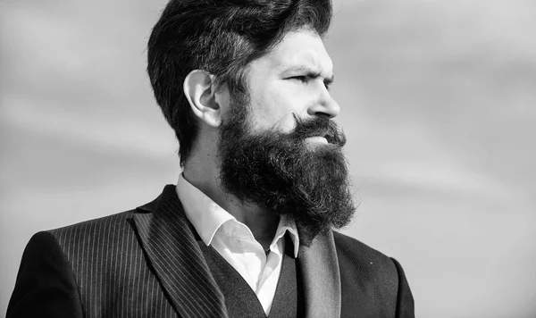 Epic beard growing guide. Vintage style long beard. Facial hair beard and mustache care. Beard fashion trend. Invest in stylish appearance. Man bearded hipster wear formal suit blue sky background