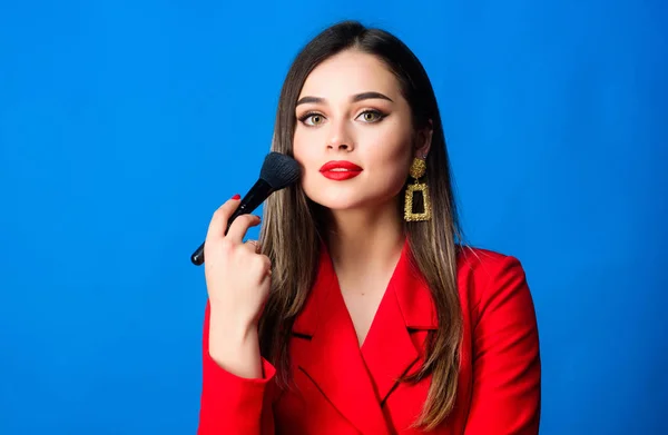 Looking good and feeling confident. Gorgeous lady makeup red lips. Fashion model tv host. Attractive woman applying makeup brush. Hiding all imperfections. Perfect skin tone. Makeup artist concept