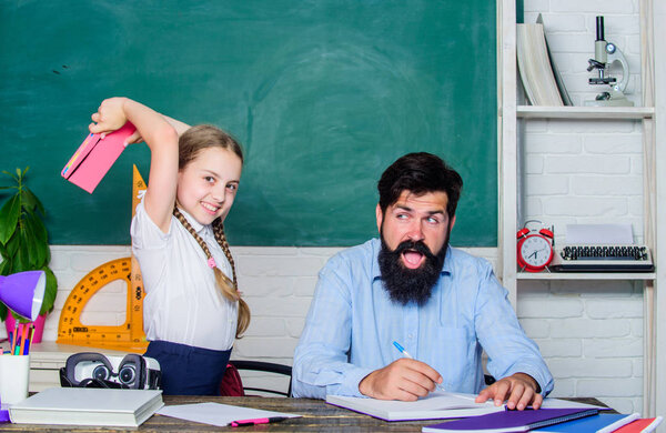 literature lesson. private lesson. small girl child with bearded teacher man in classroom. knowledge day. Home schooling. back to school. Private teaching. daughter study with father. Teachers day