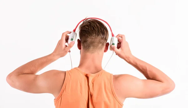 Back to basics. unshaven man listening music in headset. sexy muscular man listen sport music. man in earphones isolated on white. muscular back of music man — Stock Photo, Image