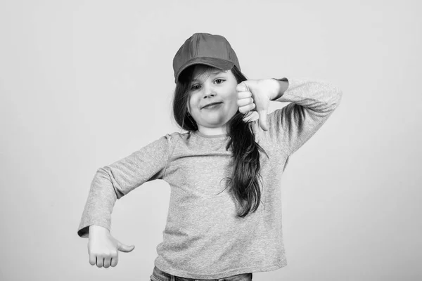 Cutie in cap. Kids fashion. Girl cute child wear cap or snapback hat beige background. Little girl wearing bright baseball cap. Modern fashion. Stylish accessory. Feeling confident with this cap — Stock Photo, Image