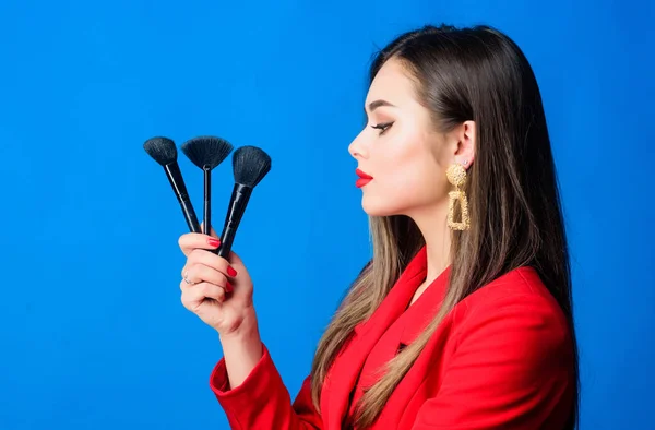 Looking good and feeling confident. Professional makeup supplies shop. Makeup courses. Gorgeous lady make up red lips. Attractive woman applying makeup brush. Perfect skin tone. Makeup artist concept