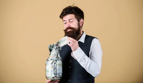 Start saving for your retirement as early as possible. Establish your budget. Businessman with his dollar savings. Security and cash money savings. Man bearded guy hold jar full of cash savings — Stock Photo, Image
