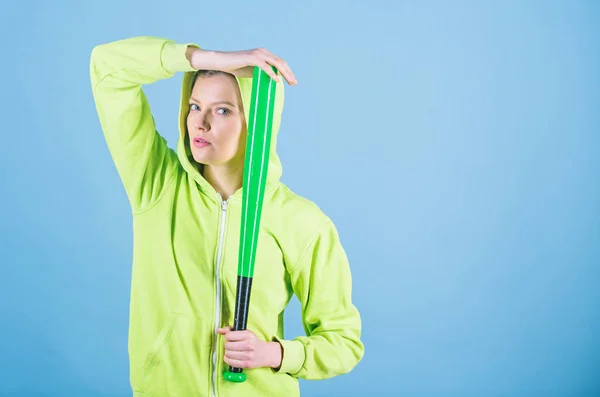 Sport game. Woman play baseball game or going to beat someone. Girl hooded jacket hold baseball bat blue background. Woman in baseball sport. Baseball female player concept. She is dangerous