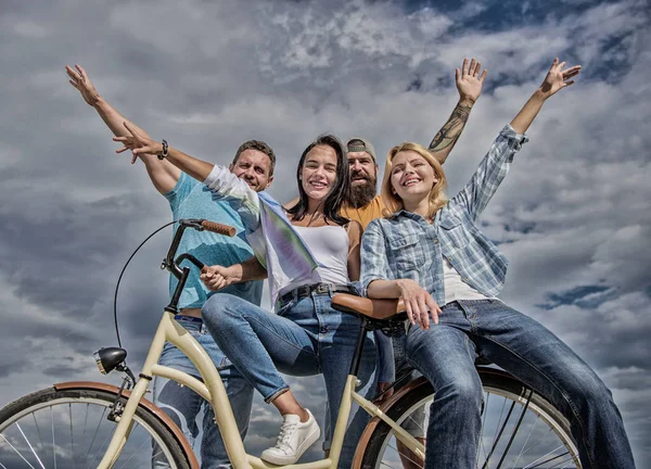 Company stylish young people spend leisure outdoors sky background. Bicycle as part of life. Cycling modernity and national culture. Group friends hang out with bicycle. Share bike live eco friendly