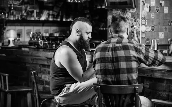 Friendship and leisure. Friday relaxation in bar. Friends relaxing in pub. Hipster brutal bearded man spend leisure with friend at bar counter. Order drinks at bar counter. Men relaxing at bar — Stock Photo, Image