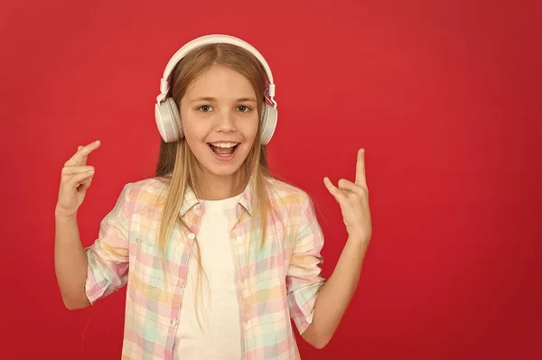 Listen to music. Beauty and fashion. small kid listen ebook, education. Childhood happiness. Mp3 player. childrens day. Audio technology. small girl child in headphones. i love music