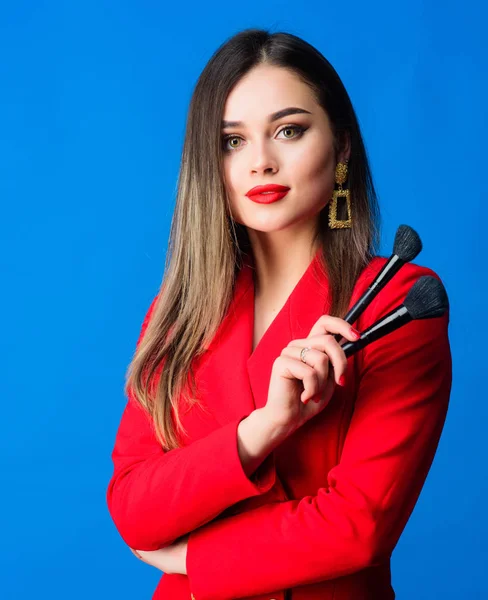 Perfect skin tone. Makeup artist concept. Looking good and feeling confident. Gorgeous lady makeup red lips. Attractive woman applying makeup brush. Strengthen confidence with bright makeup